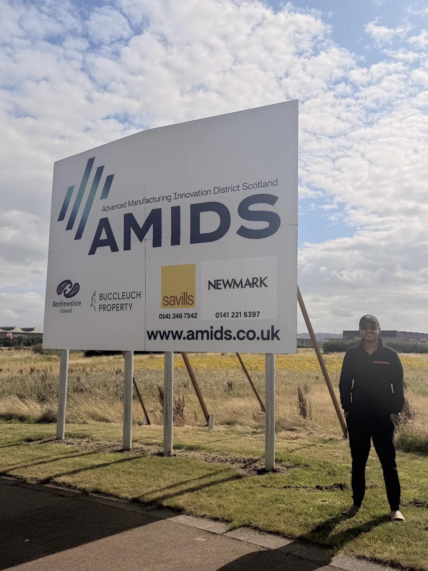 Varun Sharma beside an AMIDS sign during a visit to the wider area on 1 August 2026